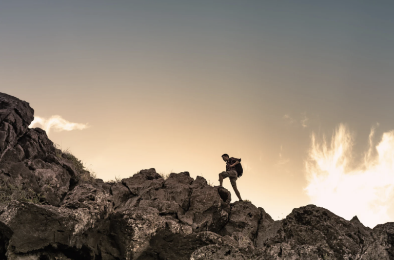 hiker climbing a mountain